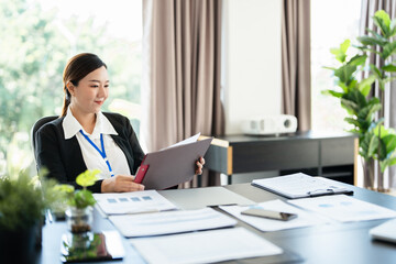 Busy mature business woman entrepreneur working in office checking legal document account invoice...
