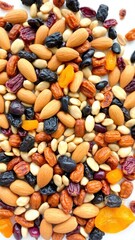 a colorful assortment of dried fruits and nuts, including almonds, raisins, dried apricots, and various seeds, spread out in a random pattern