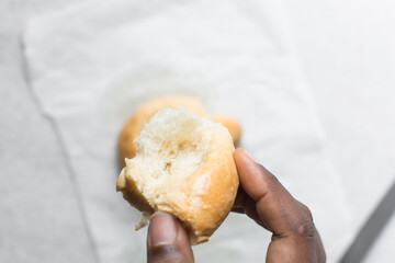 overhead view of bread being pulled apart, top view of bread with good gluten development being pulled apart, soft fluffy homemade challah being torn