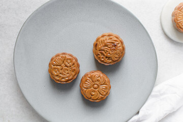 Overhead view of homemade mooncakes on a grey plate, top view of baked mooncakes, mooncakes for Lunar New Year and mid autumn festival