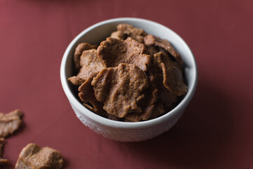 Overhead view of kuli-kuli in a white bowl, top view of nigerian groundnut cakes in a bowl