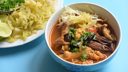 rice vermicelli with northern thai curry sauce on blue background