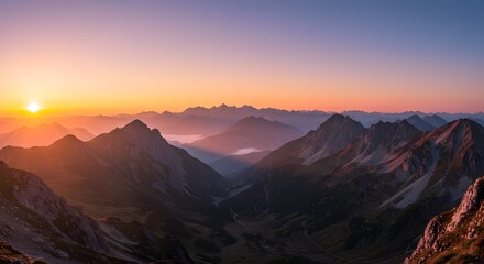 a sweeping panoramic view of mountains bathed in the early light of sunrise.