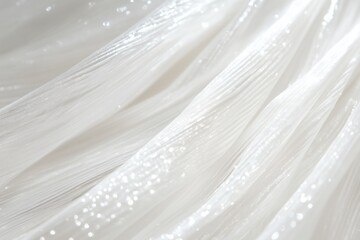 Obraz premium Close-up of shimmering white fabric with a soft, flowing texture, featuring delicate light reflections and a smooth appearance.