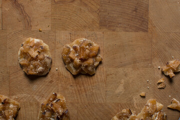 Overhead view of nigerian coconut candy, top view of candied coconuts discs, flatlay of bukayo candy or coconut drops