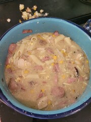 A detailed close up of a deep bowl of delicious soup placed on a table