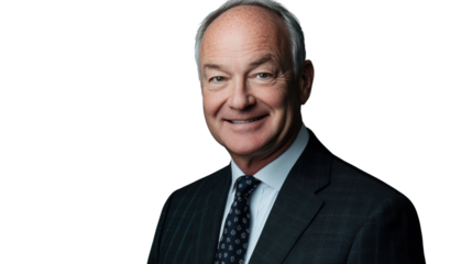 A confident businessman smiles while dressed in formal attire, exuding professionalism and approachability in a corporate setting.