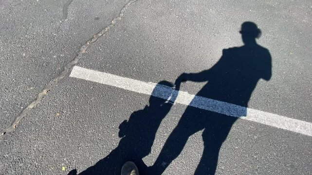 Father Helping His Baby Walk Shadow