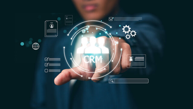 Customer relationship management CRM concept. Customer database and business marketing solutions. Businessman touching customer and CRM icons