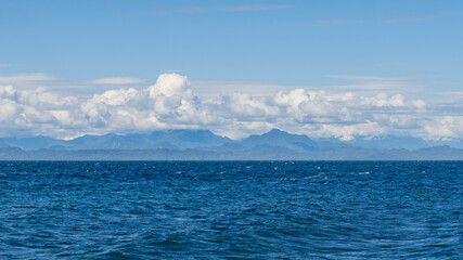 panorama view from the shore of Malcolm Island beautiful water of the ocean with clouds on blue sky