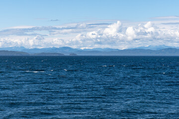panorama view from the shore of Malcolm Island beautiful water of the ocean with clouds on blue sky