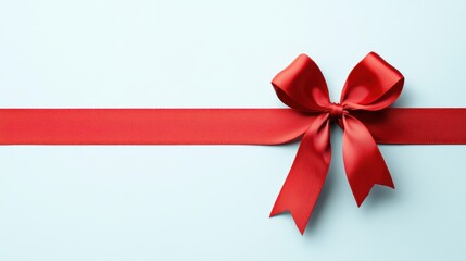Elegant Red Ribbon Bow on Soft Blue Background for Gift Wrapping and Decoration