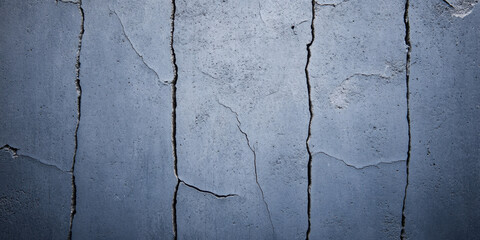 Obraz premium front view of grungy, weathered concrete wall with visible cracks and texture, showcasing raw and industrial aesthetic