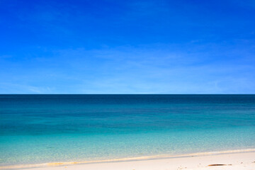 Nature of the beach and sea Summer with sunshine, sandy beaches, clear blue waters sparkling against the blue sky. On an island with good ecology and environment Background for summer vacation
