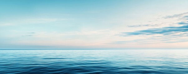 Fototapeta premium A serene seascape featuring calm waters and a soft, pastel-colored sky, capturing the tranquility of nature.