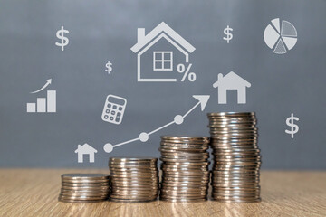 Stack of coins on the wooden table with concept of house price rising up or real estate property...