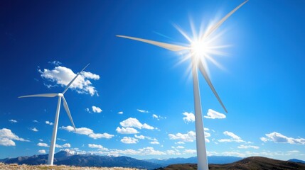 Wind Turbines Against Azure Sky and Mountain Range Generating Clean Energy in a Sunny Environment