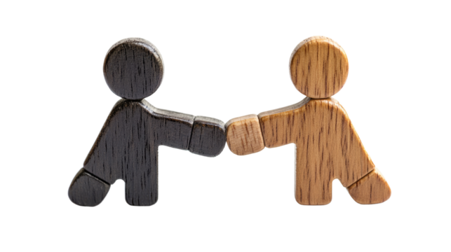 Agreement in Miniature: Wooden figures in contrasting tones engage in a fist bump, conveying a powerful message of agreement, solidarity, and collaborative spirit, set against a clean backdrop.