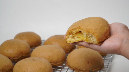 Coffee milk buns are served using a cooling rack that is placed on a white background (isolated white).