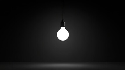 Bright Light Bulb Hanging Against Dark Background for Inspiration