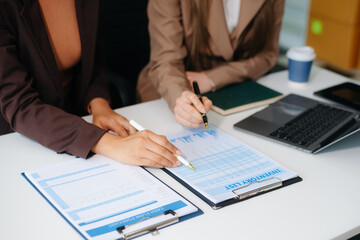 The business team analyzes revenue charts and graphs with laptop and tablet.Business analysis