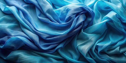 Obraz premium Draped ocean-hued silk fabric with a gradient of blue tones, showcasing its luxurious texture and flowing elegance.