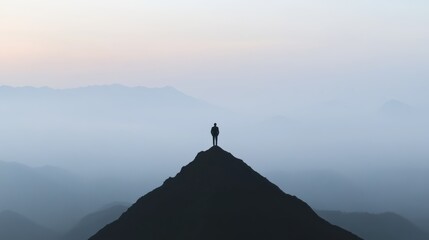 A businessman standing on a peak, looking at the sunrise,
