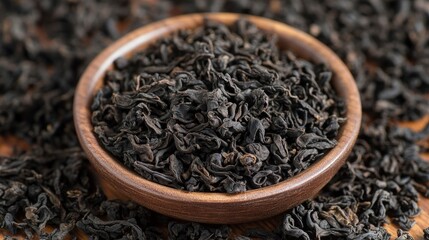 Fototapeta premium Aromatic Loose Leaf Black Tea in Wooden Bowl
