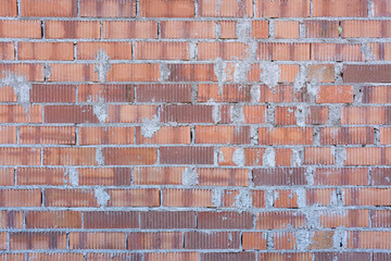 Background from a wall made of rustic red bricks