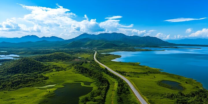 Aerial view of the road leading to Hainan's Lingshan Mountain, with green grassland