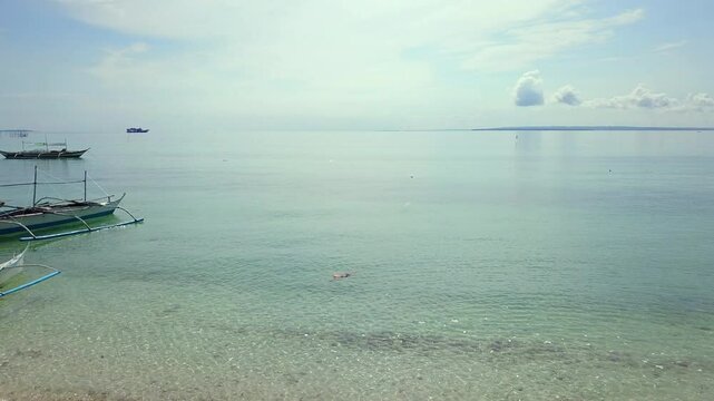 Frontal tracking shot of incredible transparent sea in Bantayan Island, Philippines