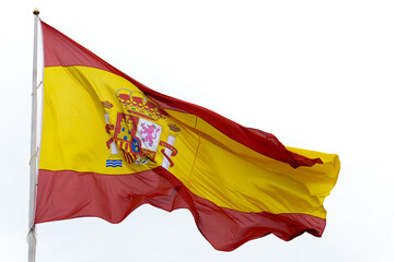 close-up of a national flag of Spain waving in the wind isolated on white background and copy space