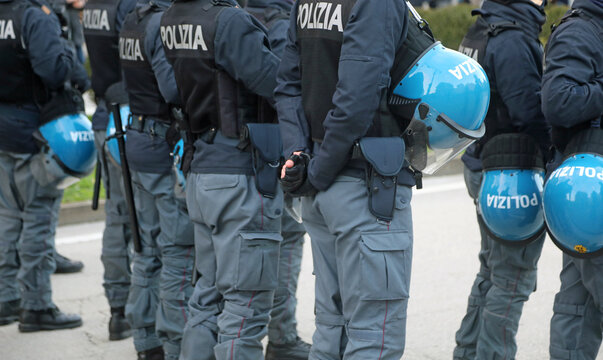 Vicenza, VI, Italy - February 15, 2025: many italian policemen in riot gear with protective helmets and text POLIZIA that means Police