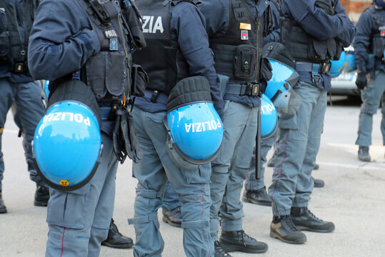 Vicenza, VI, Italy - February 15, 2025: italian policemen in riot gear with protective helmets and word POLIZIA that means Police
