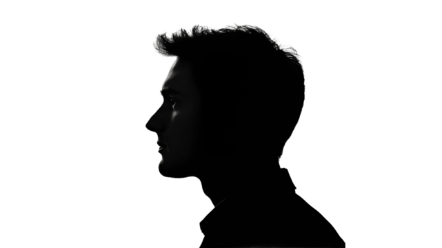 Silhouette of a young man in profile against light