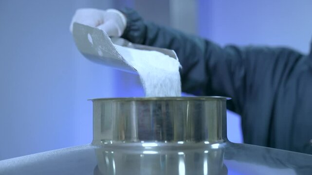 powder medicine mixing and blending process close up. dusting powder chemical pharma ingredient in a large equipment production line in a pharma manufacturing plant factory	
