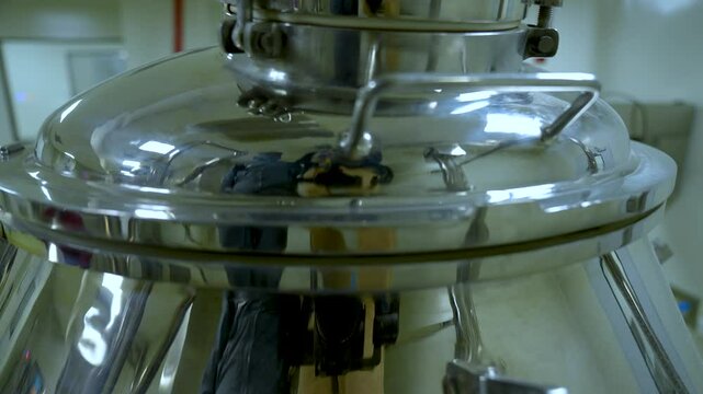 powder medicine mixing and blending process close up. dusting powder chemical pharma ingredient in a large equipment production line in a pharma manufacturing plant factory	

