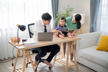Family spending quality time in a cozy home office while engaging with a child on a sunny day