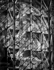 Black and white image of metal bars against a weathered concrete wall.