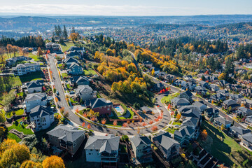Aerial drone view of Happy Valley, Oregon, in autumn, showcasing vibrant fall foliage, residential...