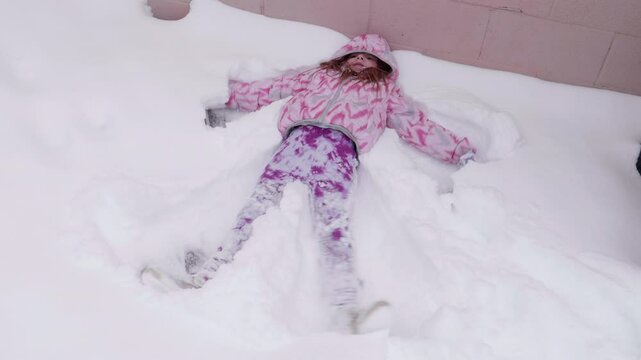 Little Girl Making a Snow Angel
