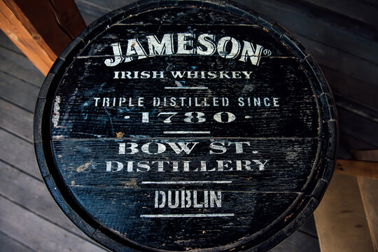 Melbourne, Australia, June 12, 2023, Jameson Irish whiskey black barrel table vintage background. A black wooden branded barrel used as a table in a street restaurant