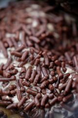 Close-up of chocolate sprinkle on a donut.