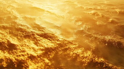 Golden sunlit ocean waves creating a serene abstract texture
