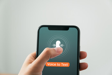 Hand holding smartphone with using voice to text application.
