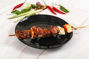 Asian grilled beef skewer with vegetables and pineapple