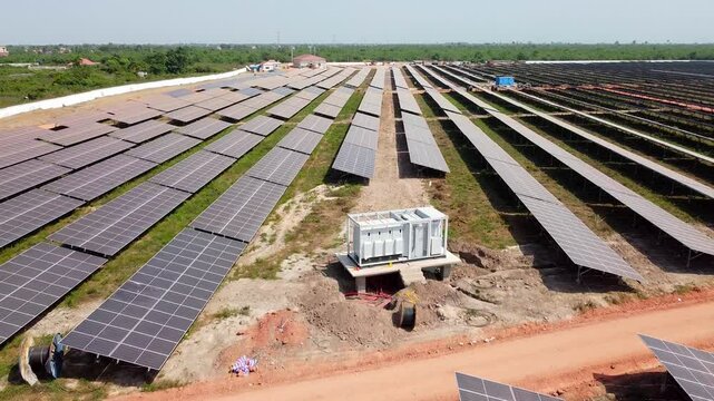 Installation and cabling of medium voltage industrial solar inverter at solar farm aerial reverse view
