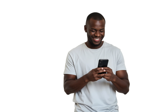 Smiling cheerful young african american man wearing casual basic tshirt standing using mobile cell phone typing text message isolated on white color wall background studio portrait.