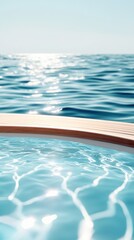 Tranquil ocean horizon and sunlit infinity pool contrast