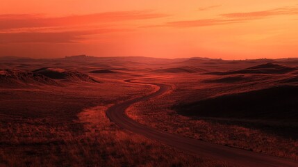 Fototapeta premium A winding road stretches across a vast expanse of land